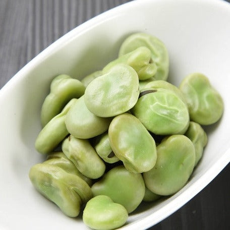 Close-up of green King of the Garden lima beans in a white bowl